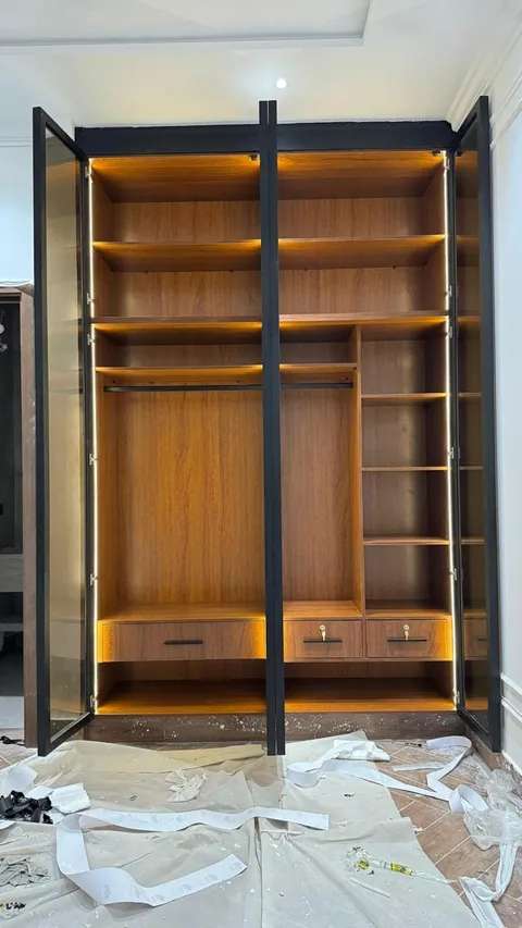 Walnut wardrobe with glass profile doors during installation