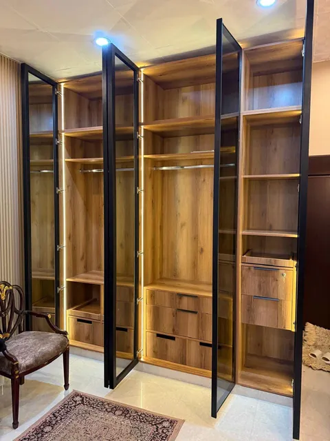 Walnut wardrobe with black glass profile doors open