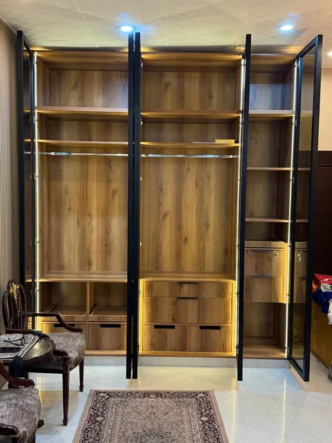 Walnut wardrobe with black glass profile doors and LED shelf lighting